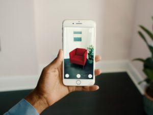 A phone running IKEA's app, which lets you test AR furniture before you buy